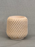 Beige textured cylindrical object on a gray background