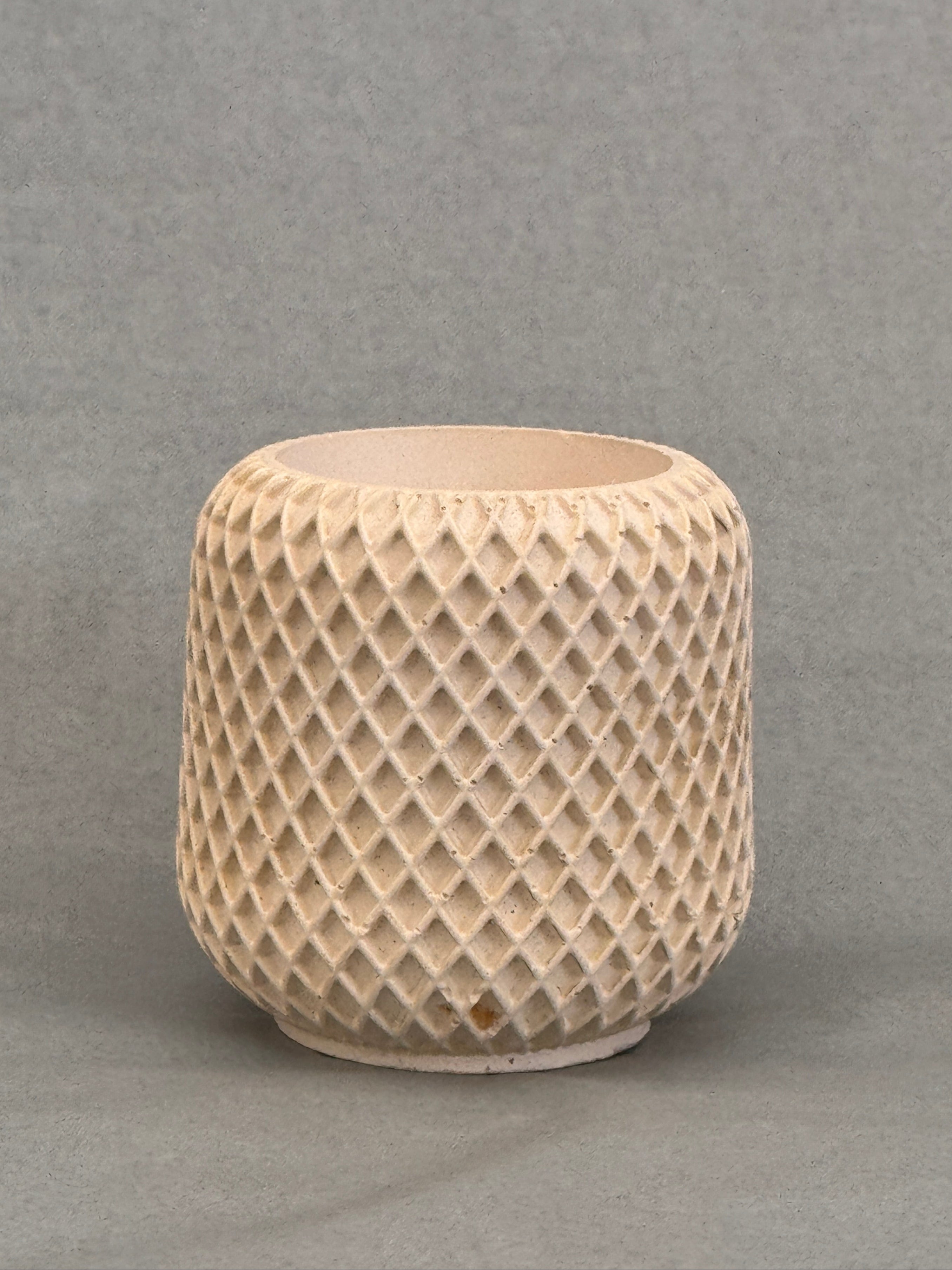 Beige textured cylindrical object on a gray background
